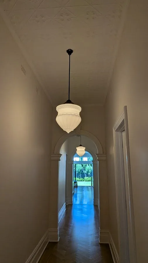 Heritage hallway with glass pendant lights