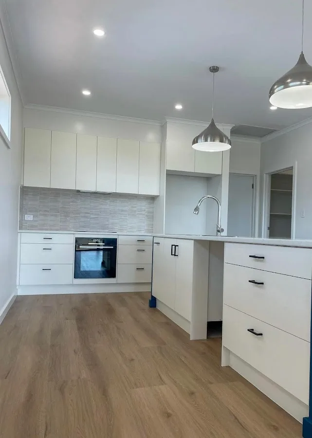 New kitchen with silver pendant lights and downlights