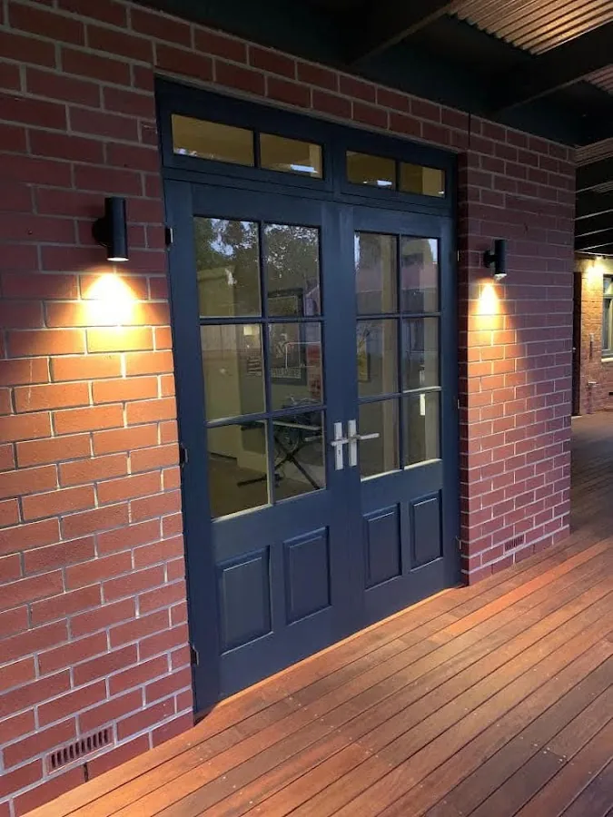 Outdoor wall lights flanking entrance on brick facade