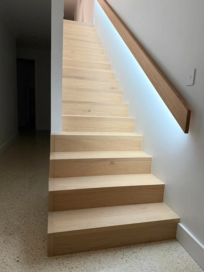 Oak staircase with LED strip lighting behind handrail