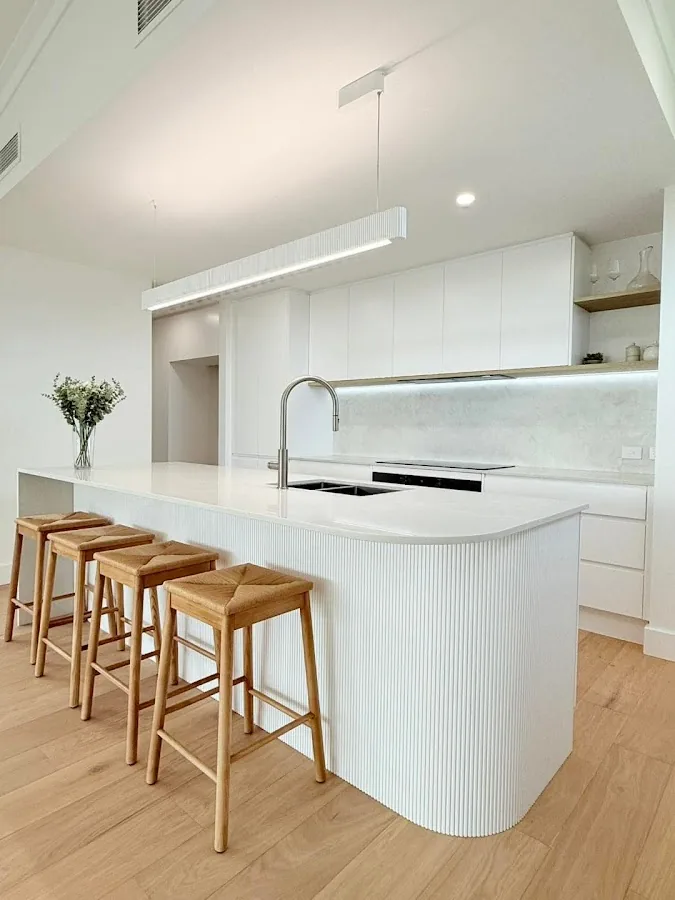 New build white kitchen with pendant lighting and downlights