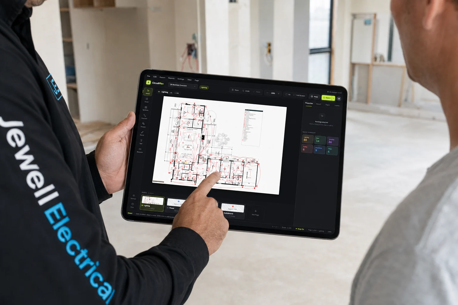 Jaeden reviewing a lighting and power plan with a client on site