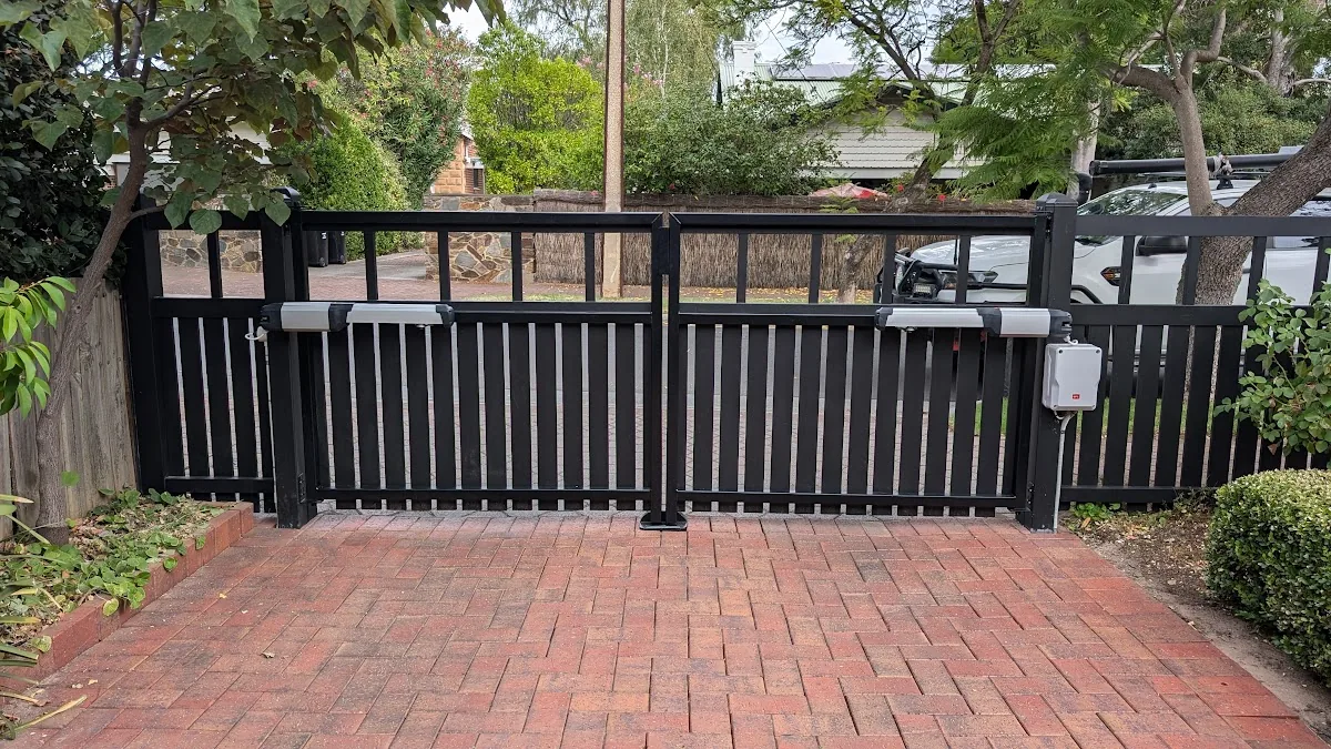 Black automated swing gates with arm motors